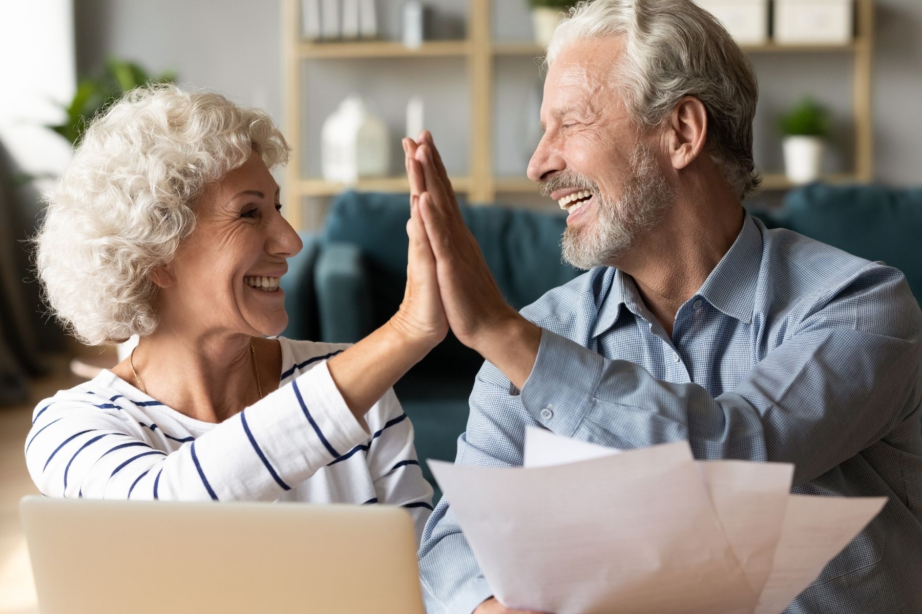 Older couple doing a high five, smiling